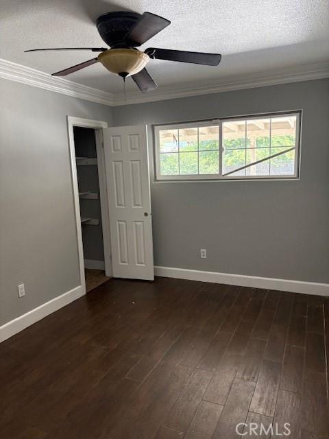 642 S Rosario Ave, San Jacinto, CA 92583 - unfurnished bedroom featuring crown molding, dark wood-style flooring, a closet, ceiling fan, and a textured ceiling