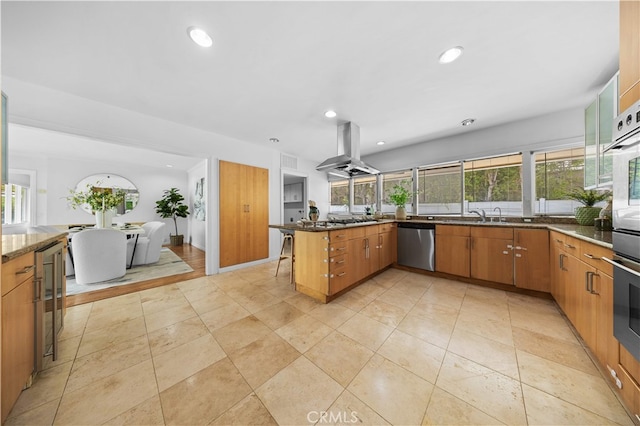 1212 Oakwood Dr, Arcadia, CA 91006 - kitchen featuring island range hood, stainless steel appliances, beverage cooler, plenty of natural light, and recessed lighting