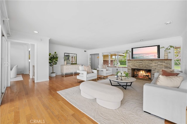 1212 Oakwood Dr, Arcadia, CA 91006 - living room with healthy amount of natural light, a stone fireplace, light wood-style floors, ornamental molding, and recessed lighting