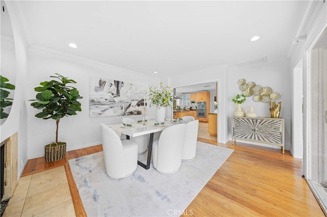 1212 Oakwood Dr, Arcadia, CA 91006 - dining space featuring crown molding, light wood-type flooring, recessed lighting, baseboards, and a fireplace