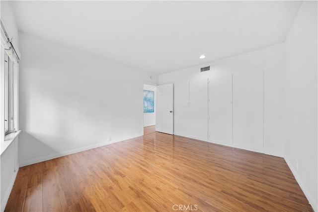 1212 Oakwood Dr, Arcadia, CA 91006 - unfurnished bedroom with wood finished floors, recessed lighting, and baseboards