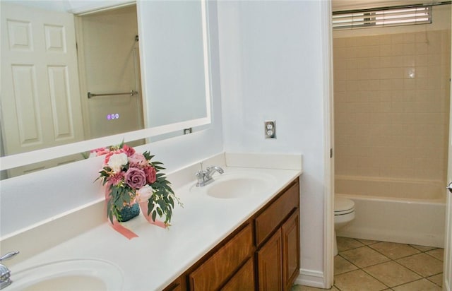 bathroom featuring tile patterned flooring, double vanity, toilet, and tub / shower combination