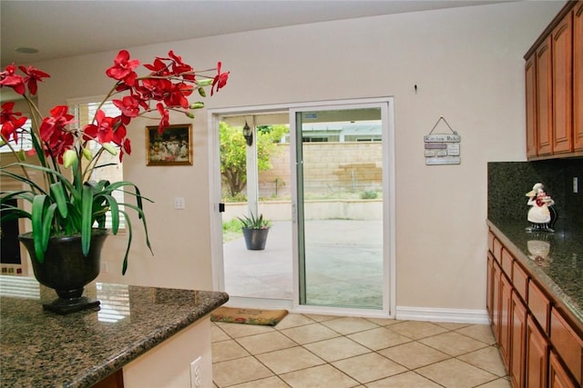 entryway featuring light tile patterned flooring and baseboards