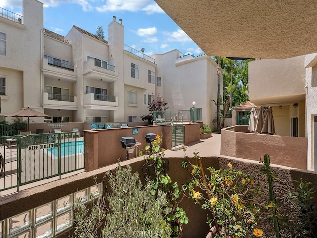 view of pool featuring fence and area for grilling