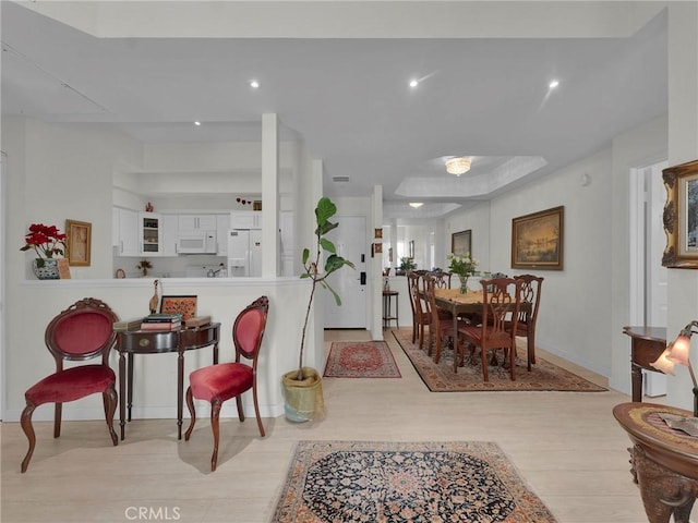 dining room featuring light wood-style floors, recessed lighting, and baseboards