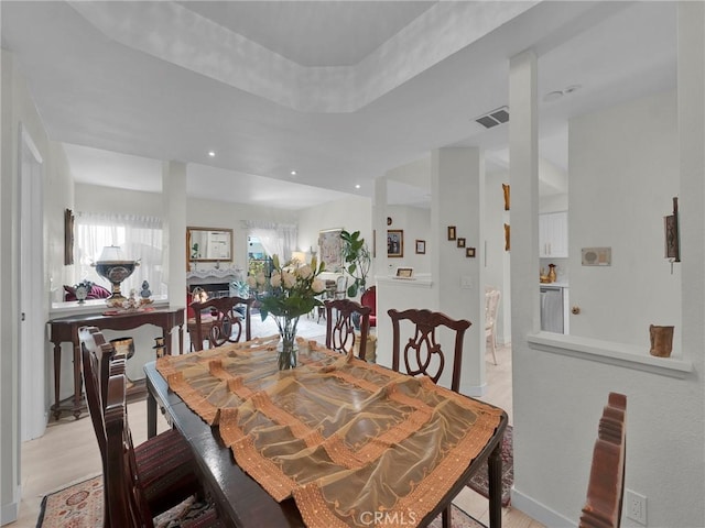 dining room featuring plenty of natural light, a fireplace, and recessed lighting
