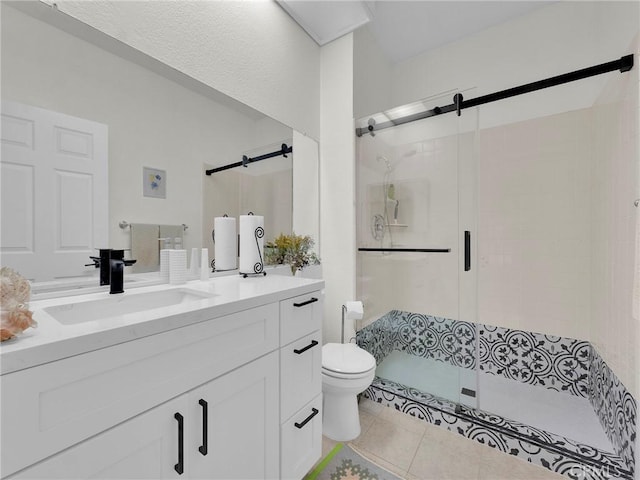 bathroom with a shower stall, toilet, tile patterned flooring, and vanity