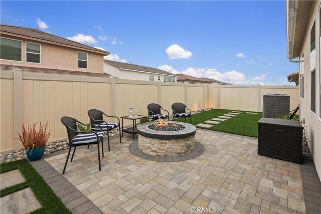 18100 Tableau Way, Saugus, CA 91350 - fenced backyard with central air condition unit, an outdoor fire pit, and a patio