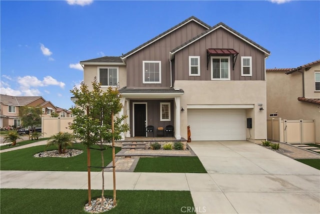 view of front of home featuring an attached garage, board and batten siding, concrete driveway, a gate, and covered porch