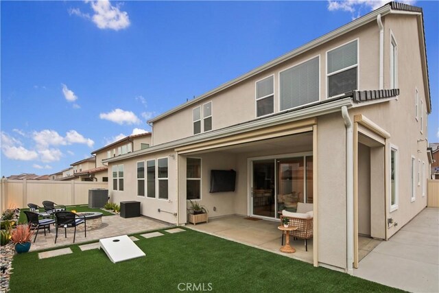 18100 Tableau Way, Saugus, CA 91350 - rear view of property featuring a fire pit, stucco siding, cooling unit, and a patio area