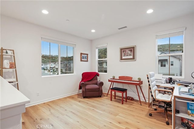office with wood finished floors, healthy amount of natural light, recessed lighting, and baseboards