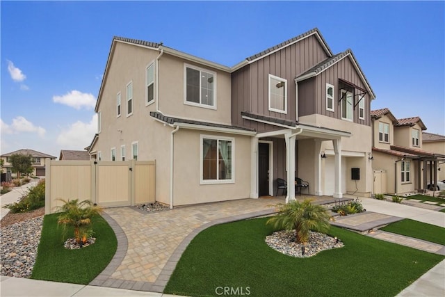 18100 Tableau Way, Saugus, CA 91350 - view of front of property featuring an attached garage, stucco siding, board and batten siding, and a residential view