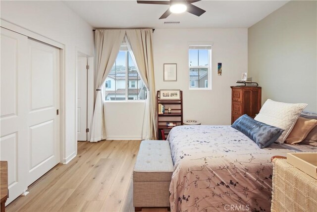 18100 Tableau Way, Saugus, CA 91350 - bedroom with light wood-style floors, multiple windows, baseboards, and ceiling fan