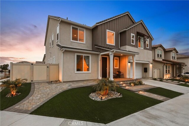 18100 Tableau Way, Saugus, CA 91350 - view of front of property featuring a gate, board and batten siding, stucco siding, and concrete driveway