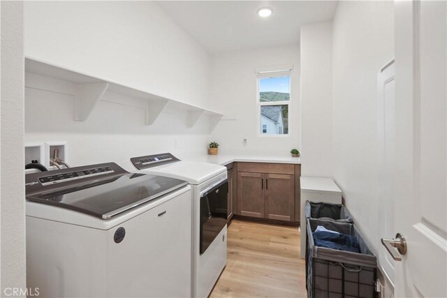 18100 Tableau Way, Saugus, CA 91350 - laundry room with independent washer and dryer, light wood-style floors, cabinet space, and recessed lighting
