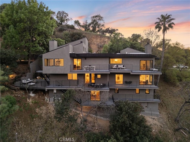 3250 Coldwater Canyon Ave, Studio City, CA 91604 - rear view of property with a chimney, a balcony, and stairway