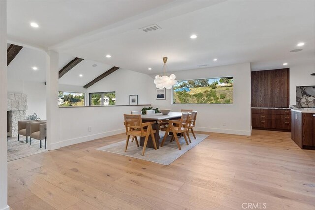 3250 Coldwater Canyon Ave, Studio City, CA 91604 - dining room with light wood-type flooring, baseboards, recessed lighting, a chandelier, and a stone fireplace