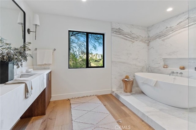 3250 Coldwater Canyon Ave, Studio City, CA 91604 - full bath with a freestanding bath, recessed lighting, wood finished floors, baseboards, and vanity