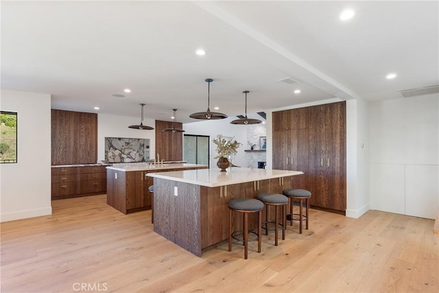 3250 Coldwater Canyon Ave, Studio City, CA 91604 - kitchen with a spacious island, light wood-style floors, light countertops, modern cabinets, and recessed lighting