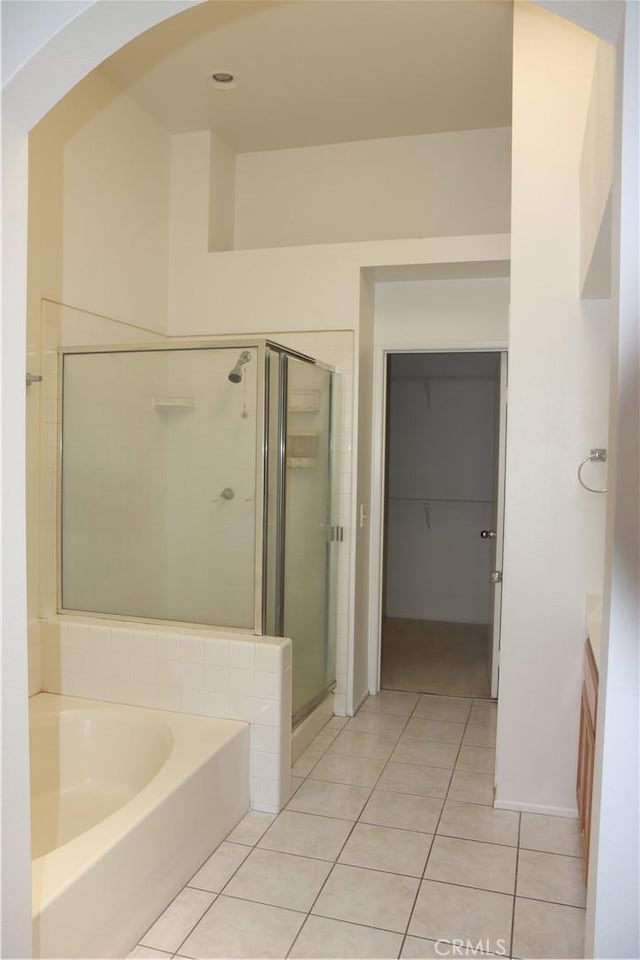 1044 Turner Ave Unit 207, Ontario, CA 91764 - bathroom featuring vanity, a garden tub, a shower stall, and tile patterned floors