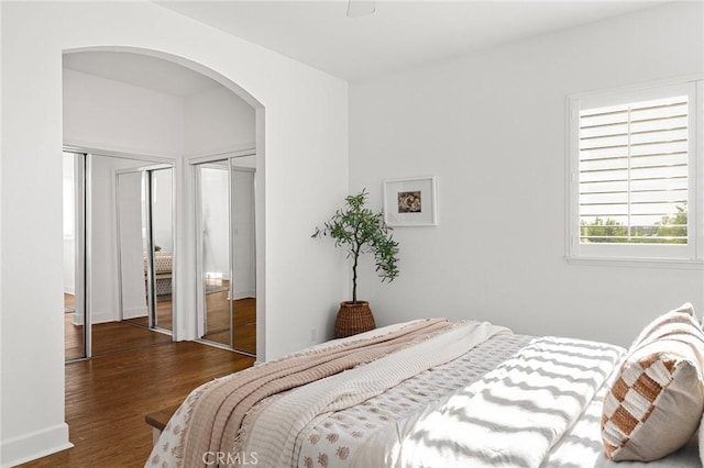 121 Wawona Pl, Chico, CA 95928 - bedroom with multiple closets, arched walkways, and wood finished floors
