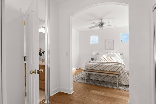 121 Wawona Pl, Chico, CA 95928 - bedroom featuring arched walkways, wood finished floors, baseboards, and ceiling fan