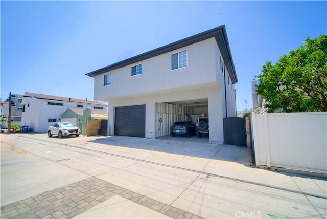 308 13th St, Seal Beach, CA 90740 - view of front of house featuring stucco siding, driveway, and an attached garage