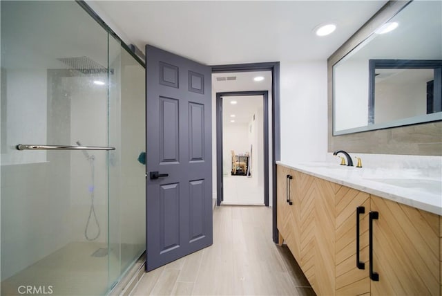 308 13th St, Seal Beach, CA 90740 - bathroom with a shower stall, double vanity, and wood finished floors