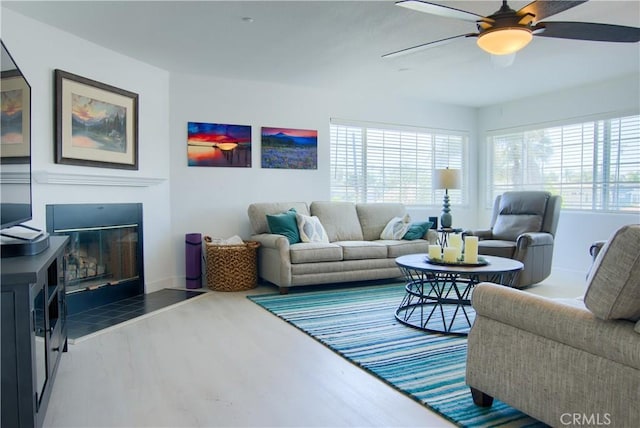 308 13th St, Seal Beach, CA 90740 - living area with wood finished floors, a ceiling fan, a glass covered fireplace, and baseboards