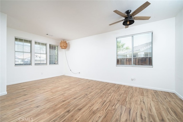 126 Schooner Ct, San Jacinto, CA 92583 - empty room featuring light wood finished floors, ceiling fan, and baseboards