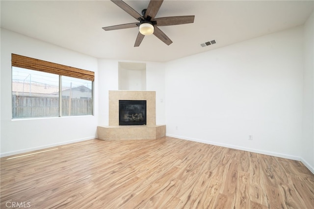 126 Schooner Ct, San Jacinto, CA 92583 - unfurnished living room featuring light wood-style flooring, a ceiling fan, a fireplace, and baseboards