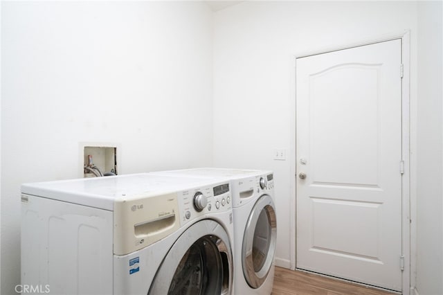 126 Schooner Ct, San Jacinto, CA 92583 - laundry room with washer and dryer and light wood finished floors
