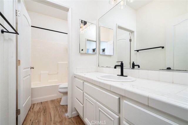 126 Schooner Ct, San Jacinto, CA 92583 - full bath with wood finished floors, toilet, vanity, and bathing tub / shower combination