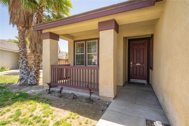 126 Schooner Ct, San Jacinto, CA 92583 - property entrance featuring stucco siding and a porch