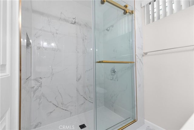 full bath featuring a marble finish shower