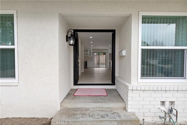 doorway to property with stucco siding