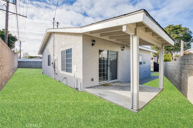 rear view of property featuring stucco siding and a patio area