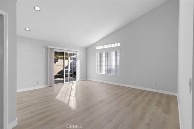 spare room with lofted ceiling, baseboards, light wood-type flooring, and recessed lighting