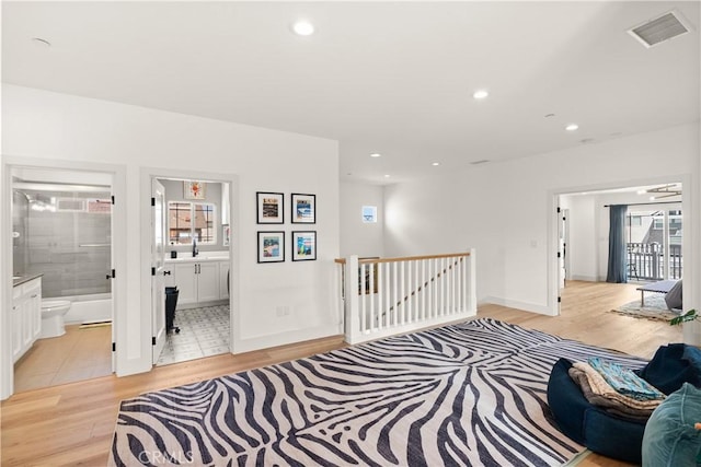 315 Lugonia St, Newport Beach, CA 92663 - hallway with light wood finished floors, an upstairs landing, a sink, baseboards, and recessed lighting