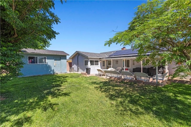 5136 W W Ave L8, Lancaster, CA 93536 - back of house with solar panels, a patio area, and a yard