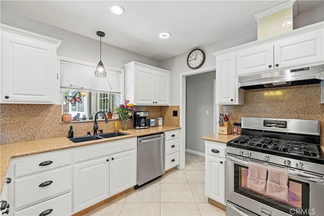 5136 W W Ave L8, Lancaster, CA 93536 - kitchen with stainless steel appliances, under cabinet range hood, a sink, white cabinets, and backsplash