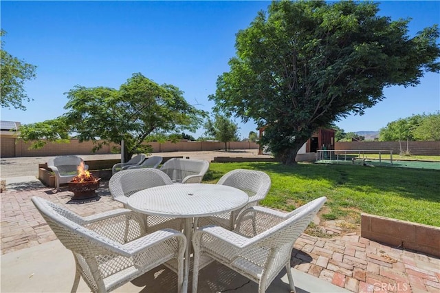 5136 W W Ave L8, Lancaster, CA 93536 - view of patio featuring a fire pit and outdoor dining area