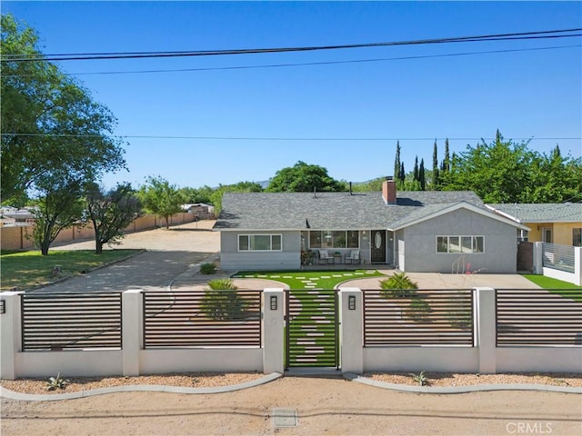5136 W W Ave L8, Lancaster, CA 93536 - view of front of house with a fenced front yard, a chimney, a gate, and roof with shingles