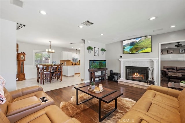 5136 W W Ave L8, Lancaster, CA 93536 - living area with a glass covered fireplace, a chandelier, recessed lighting, light wood-style floors, and baseboards