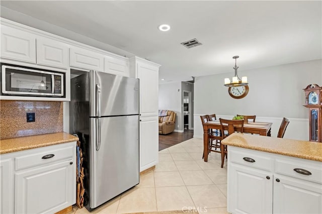 5136 W W Ave L8, Lancaster, CA 93536 - kitchen with stainless steel appliances, light countertops, white cabinets, a chandelier, and recessed lighting