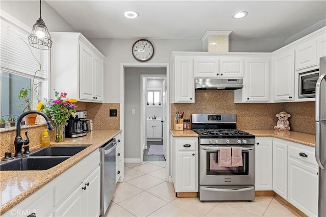 5136 W W Ave L8, Lancaster, CA 93536 - kitchen with stainless steel appliances, under cabinet range hood, a sink, white cabinets, and light tile patterned floors