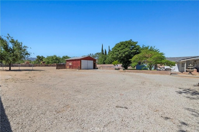 5136 W W Ave L8, Lancaster, CA 93536 - view of yard with a garage, an outbuilding, and dirt driveway