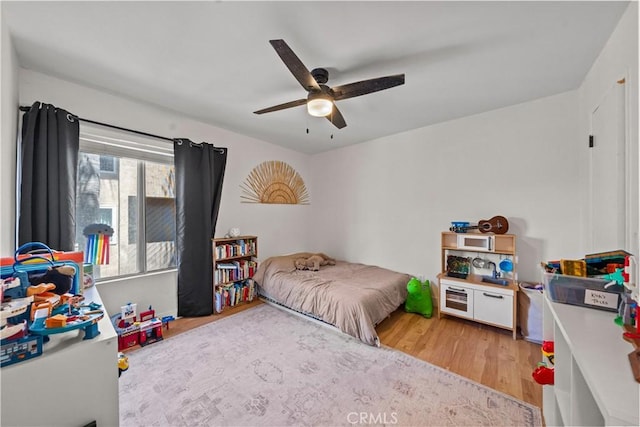 bedroom with light wood-type flooring and a ceiling fan