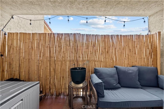 view of patio featuring an outdoor hangout area and fence