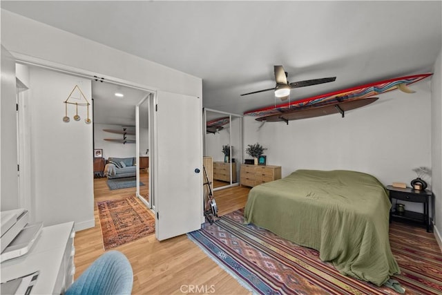bedroom with light wood-style flooring and a ceiling fan